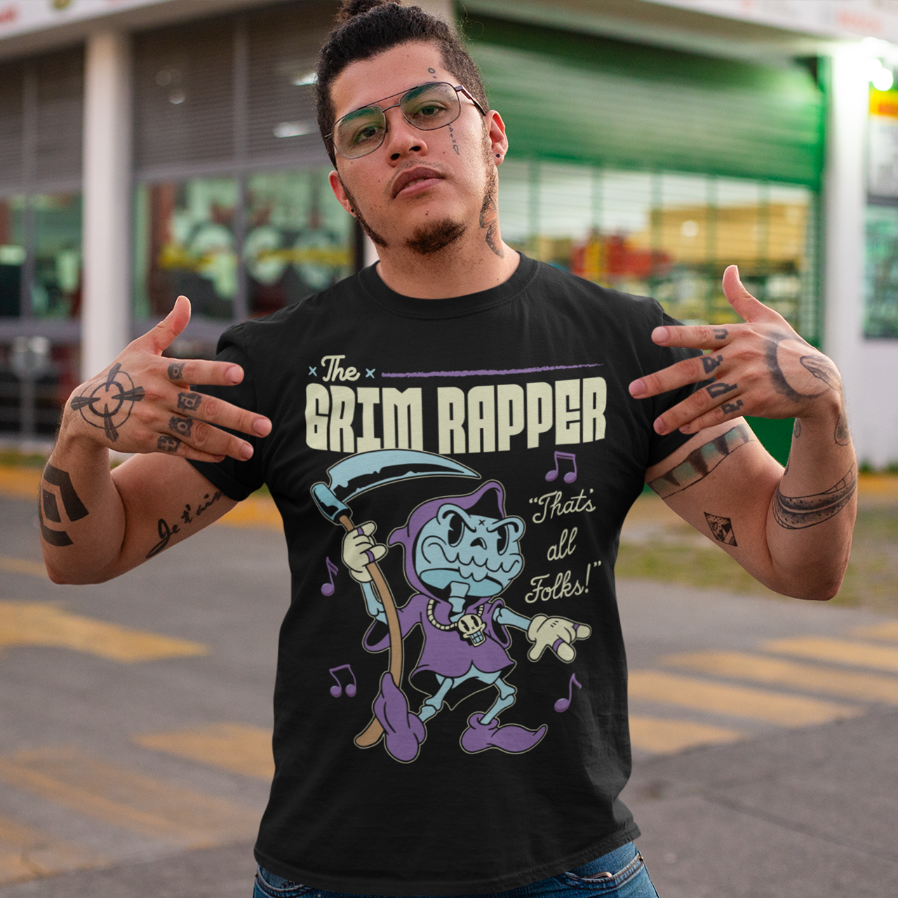 Black t-shirt of a cartoon rapper grim reaper with musical notes and text above THE GRIM RAPPER