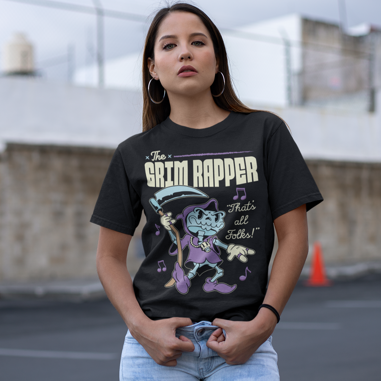 Black t-shirt of a cartoon rapper grim reaper with musical notes and text above THE GRIM RAPPER