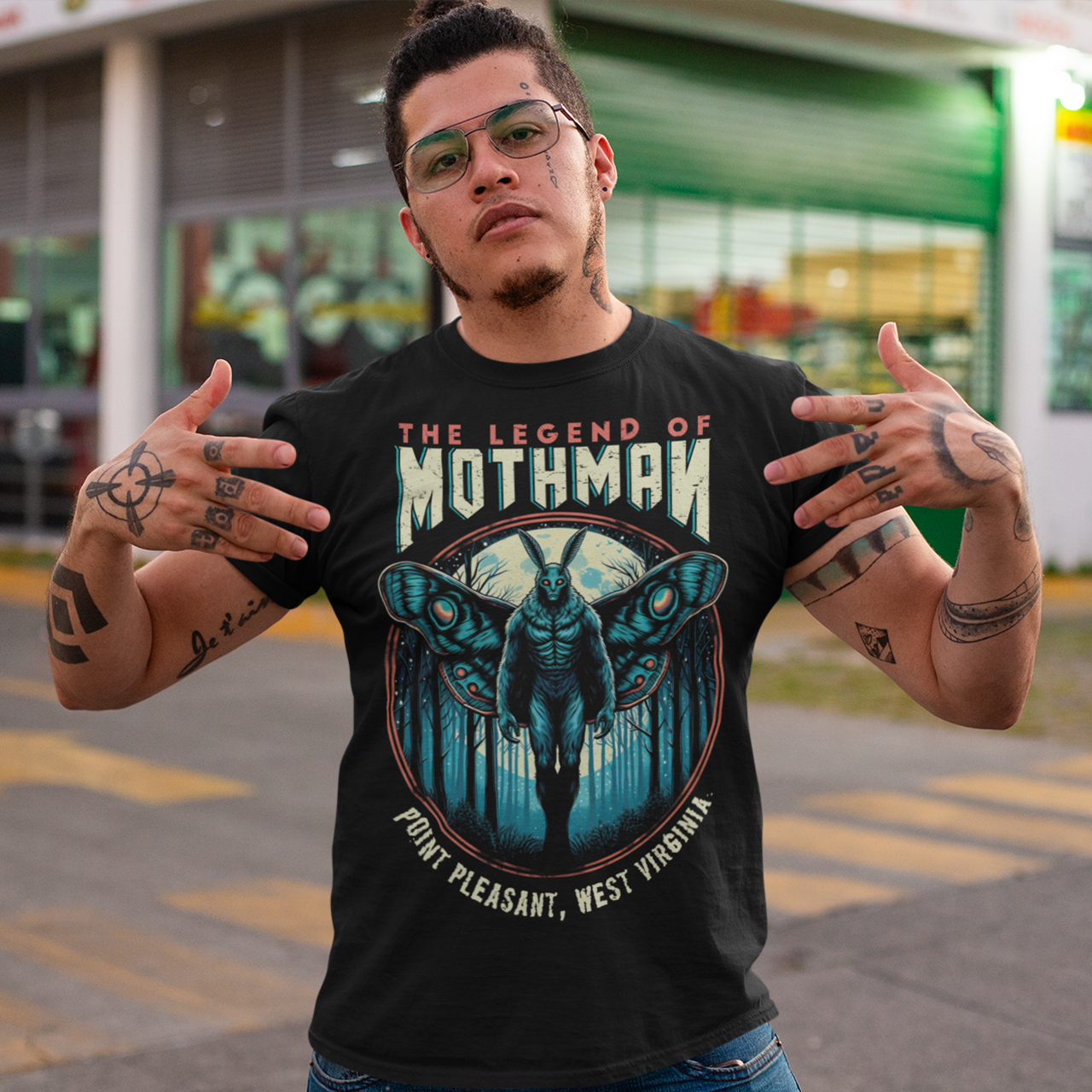 Black t-shirt of Mothman in a forest with text above THE LEGEND OF MOTHMAN.