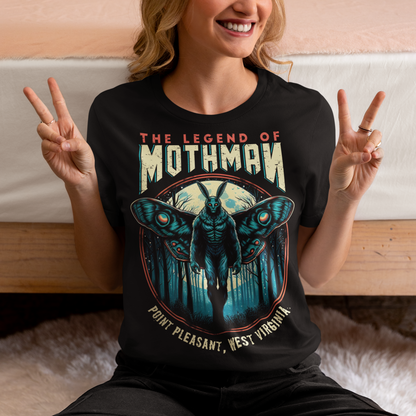 This captivating t-shirt features a striking illustration of Mothman, the legendary cryptid, standing mysteriously in a dense, shadowy forest. The eerie scene captures the essence of folklore, with Mothman's glowing red eyes piercing through the darkness, creating an atmosphere of both intrigue and suspense. Above the enigmatic figure, bold text reads "THE LEGEND OF MOTHMAN," adding to the mystique and allure of this mythical creature.