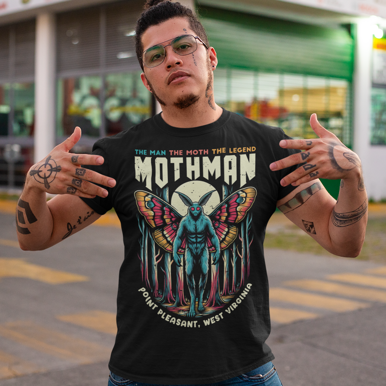 Black t-shirt of Mothman in a forest with text above THE MAN THE MOTH THE LEGEND MOTHMAN.