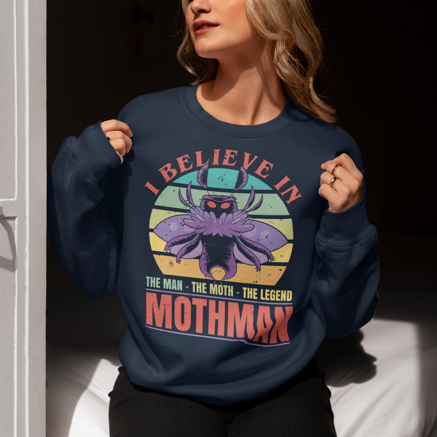 Navy sweatshirt of Mothman with a retro sun background with text "THE MAN THE MOTH THE LEGEND".