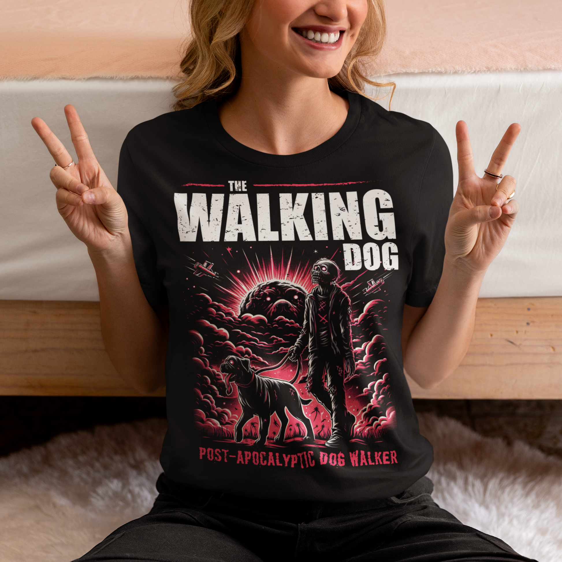 Black t-shirt of a zombie walking a dog in the apocalypse with text above THE WALKING DOG and text below POST-APOCALYPTIC DOG WALKER.