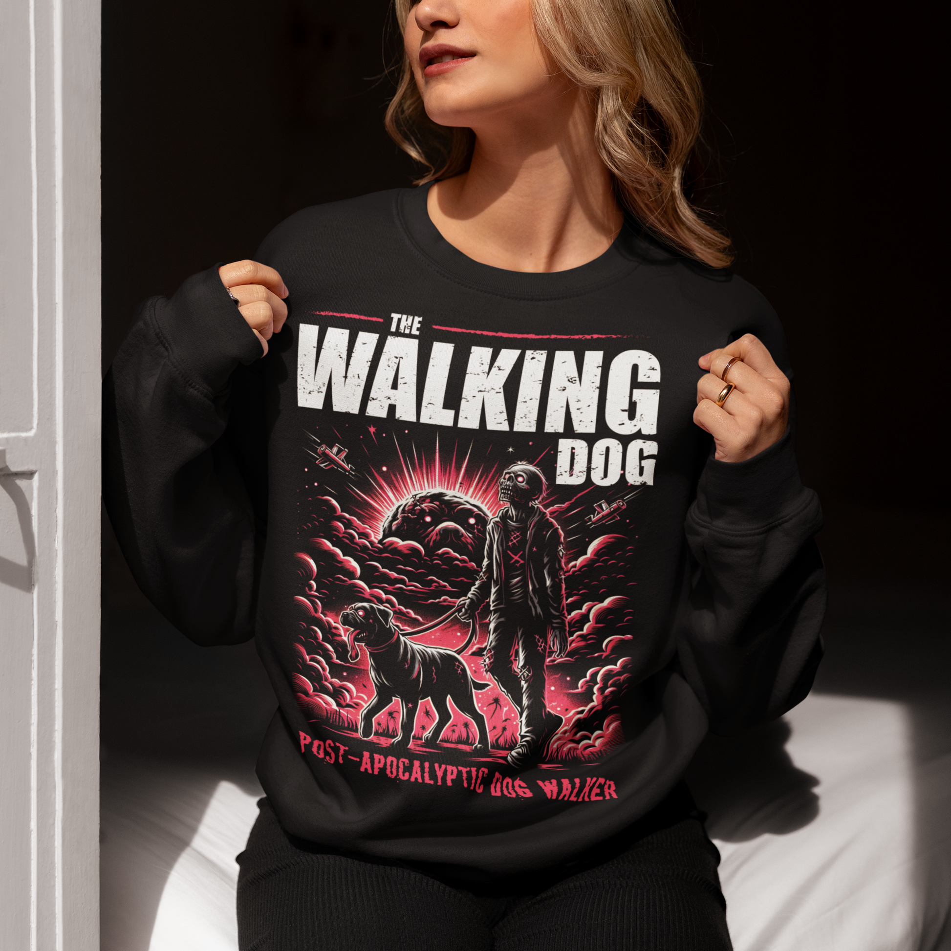 Black sweatshirt of a zombie walking a dog in the apocalypse with text above THE WALKING DOG and text below POST-APOCALYPTIC DOG WALKER.