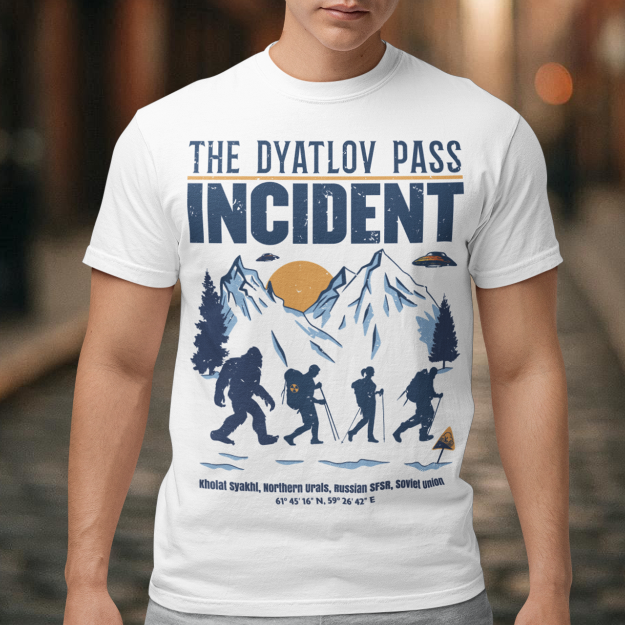 Embark on an enigmatic journey with our captivating 'Dyatlov Pass Incident' t-shirt! This unique design captures the mystique of snowy mountain ranges, featuring a group of adventurous hikers traversing the wintry landscape. Amidst the serene snow-covered peaks, mysterious UFOs hover above, adding an element of otherworldly intrigue to the scene. At the tail end of the group stands the elusive figure of Bigfoot, shrouded in the enigma of the untamed wilderness.