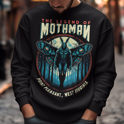 This captivating sweatshirt features a striking illustration of Mothman, the legendary cryptid, standing mysteriously in a dense, shadowy forest. The eerie scene captures the essence of folklore, with Mothman's glowing red eyes piercing through the darkness, creating an atmosphere of both intrigue and suspense. Above the enigmatic figure, bold text reads "THE LEGEND OF MOTHMAN," adding to the mystique and allure of this mythical creature.