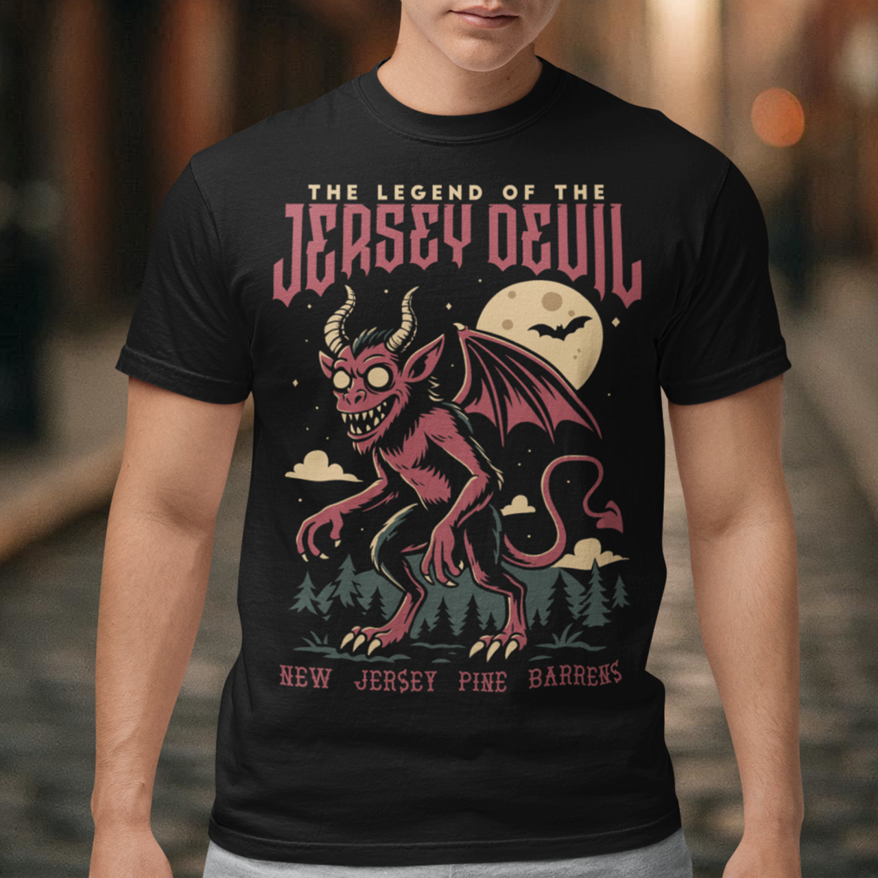 "Embrace the mystery with our Jersey Devil t-shirt! Featuring a striking depiction of the legendary creature , this shirt captures the intrigue and folklore of the New Jersey Pine Barrens. Above, bold letters declare 'THE LEGEND OF THE JERSEY DEVIL,' invoking tales of its enigmatic presence. Below, 'THE NEW JERSEY PINE BARRENS' grounds the design in the eerie beauty of its natural habitat. Wear it to ignite conversations and inspire curiosity about this enduring myth."