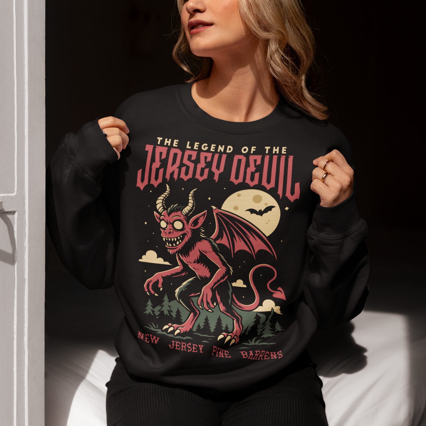 "Embrace the mystery with our Jersey Devil sweatshirt! Featuring a striking depiction of the legendary creature , this shirt captures the intrigue and folklore of the New Jersey Pine Barrens. Above, bold letters declare 'THE LEGEND OF THE JERSEY DEVIL,' invoking tales of its enigmatic presence. Below, 'THE NEW JERSEY PINE BARRENS' grounds the design in the eerie beauty of its natural habitat. Wear it to ignite conversations and inspire curiosity about this enduring myth."