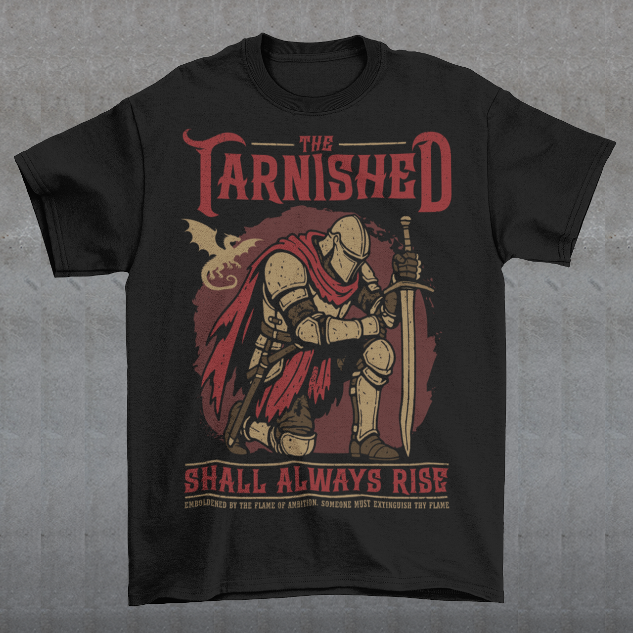 Black t-shirt featuring a dark fantasy design of a kneeling armored knight holding a sword with red accents and a dragon silhouette in the background. Large text reads “The Tarnished Shall Always Rise,” with smaller medieval-style text underneath. Inspired by fantasy RPG and soulslike gaming aesthetics.