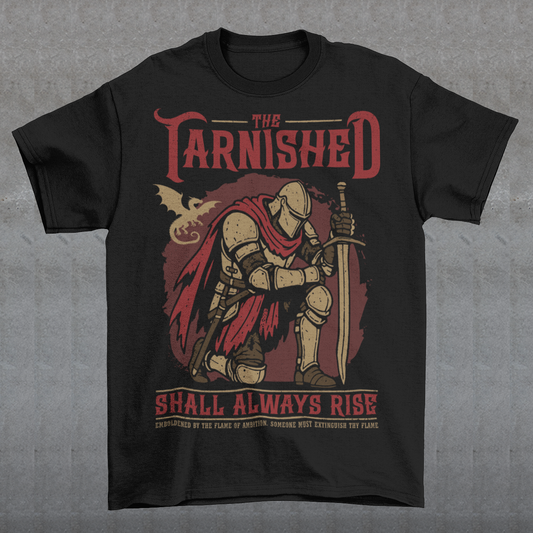 Black t-shirt featuring a dark fantasy design of a kneeling armored knight holding a sword with red accents and a dragon silhouette in the background. Large text reads “The Tarnished Shall Always Rise,” with smaller medieval-style text underneath. Inspired by fantasy RPG and soulslike gaming aesthetics.