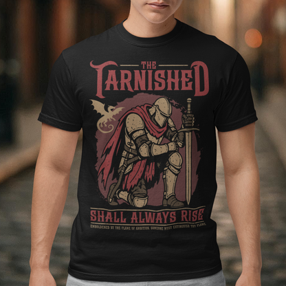 Black t-shirt featuring a dark fantasy design of a kneeling armored knight holding a sword with red accents and a dragon silhouette in the background. Large text reads “The Tarnished Shall Always Rise,” with smaller medieval-style text underneath. Inspired by fantasy RPG and soulslike gaming aesthetics.