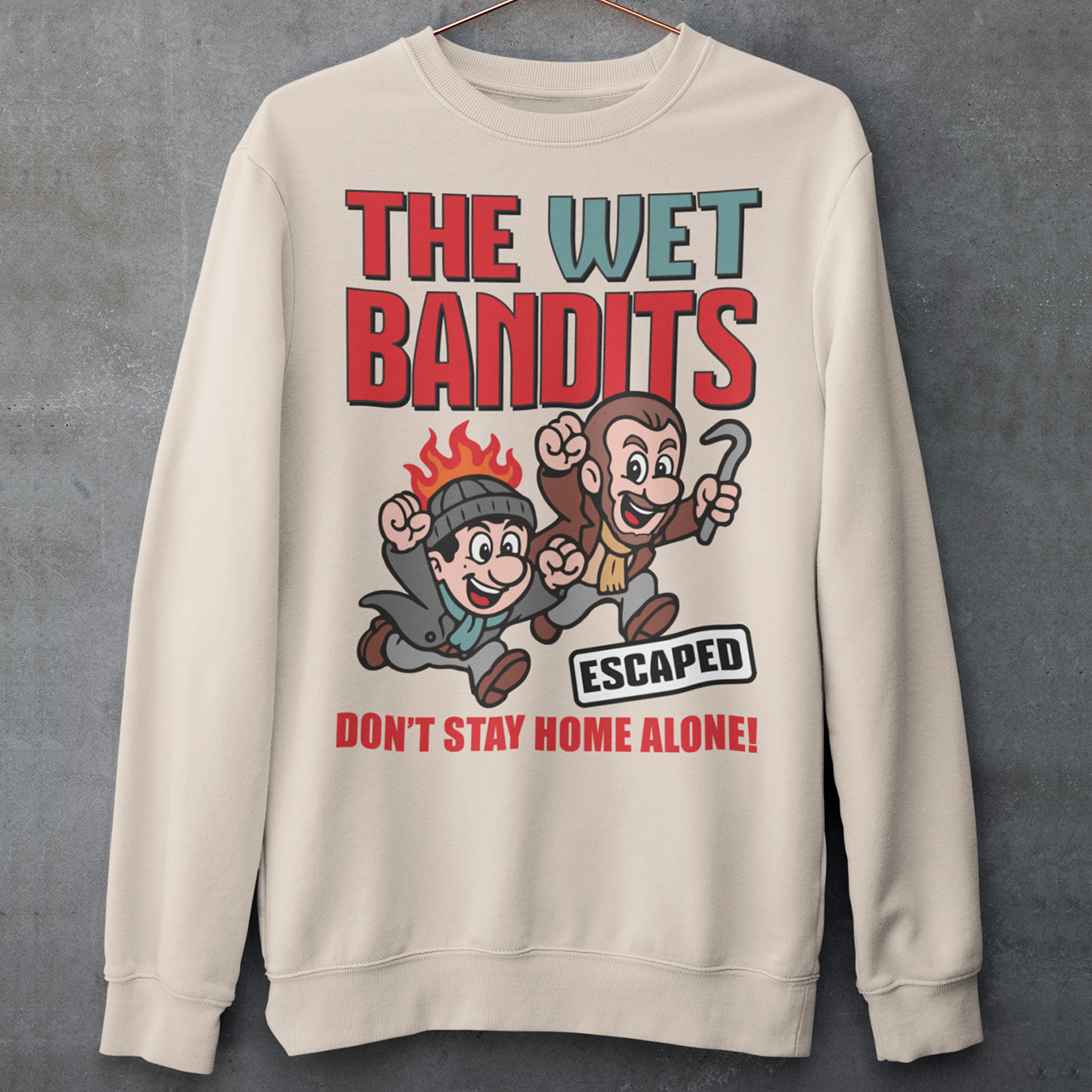 Bring some nostalgic mischief to your wardrobe with this “The Wet Bandits – Don’t Stay Home Alone!” sweatshirt! Inspired by the classic holiday comedy, this fun retro-style design features a cartoon version of the iconic burglar duo in bold, vintage colors. Perfect for fans of 90s movies, Christmas classics, and throwback humor, this shirt blends playful artwork with cozy comfort.