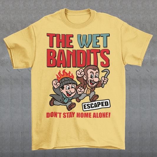 Bring some nostalgic mischief to your wardrobe with this “The Wet Bandits – Don’t Stay Home Alone!” t-shirt! Inspired by the classic holiday comedy, this fun retro-style design features a cartoon version of the iconic burglar duo in bold, vintage colors. Perfect for fans of 90s movies, Christmas classics, and throwback humor, this shirt blends playful artwork with cozy comfort.