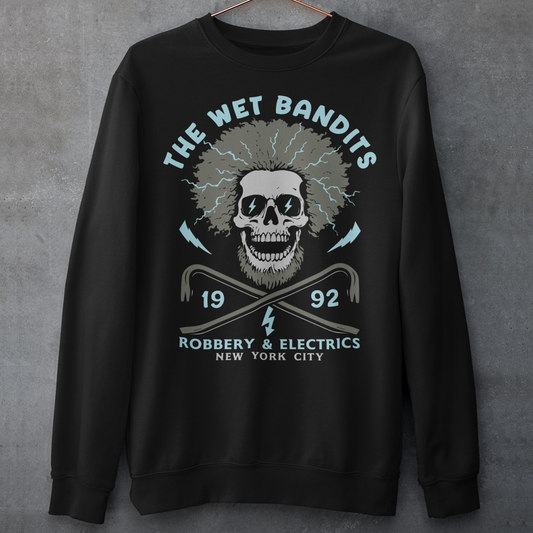 Shock your style to life with this “The Wet Bandits – Robbery And Electrics” sweatshirt! Featuring a bold skull design with wild electric hair, crossed crowbars, and vintage lettering, this tee blends rock-n-roll attitude with classic movie nostalgia. Inspired by the unforgettable duo from the holiday favorite, it’s perfect for fans who love edgy humor and retro vibes.