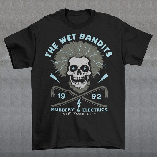 Shock your style to life with this “The Wet Bandits – Robbery And Electrics” t-shirt! Featuring a bold skull design with wild electric hair, crossed crowbars, and vintage lettering, this tee blends rock-n-roll attitude with classic movie nostalgia. Inspired by the unforgettable duo from the holiday favorite, it’s perfect for fans who love edgy humor and retro vibes.