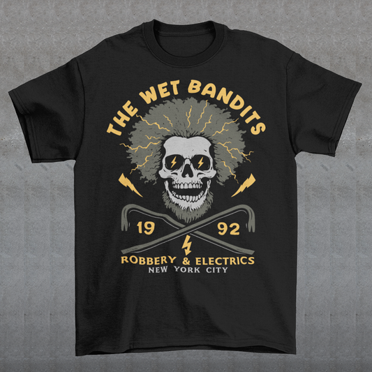 Shock your style to life with this “The Wet Bandits – Robbery &amp; Electrics” t-shirt! Featuring a bold skull design with wild electric hair, crossed crowbars, and vintage lettering, this tee blends rock-n-roll attitude with classic movie nostalgia. Inspired by the unforgettable duo from the holiday favorite, it’s perfect for fans who love edgy humor and retro vibes.