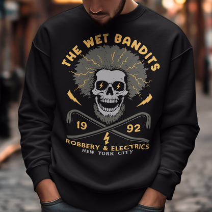 Shock your style to life with this “The Wet Bandits – Robbery And Electrics” sweatshirt! Featuring a bold skull design with wild electric hair, crossed crowbars, and vintage lettering, this tee blends rock-n-roll attitude with classic movie nostalgia. Inspired by the unforgettable duo from the holiday favorite, it’s perfect for fans who love edgy humor and retro vibes.