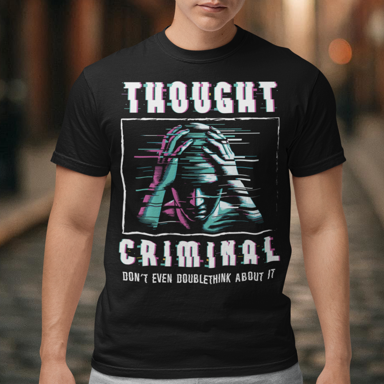 This bold and edgy T-shirt features the phrase "THOUGHT CRIMINAL" in a glitched, distorted font, giving it a rebellious, cyberpunk-inspired aesthetic. The design evokes themes of censorship, free thought, and dystopian resistance, making it perfect for those who challenge the status quo.
