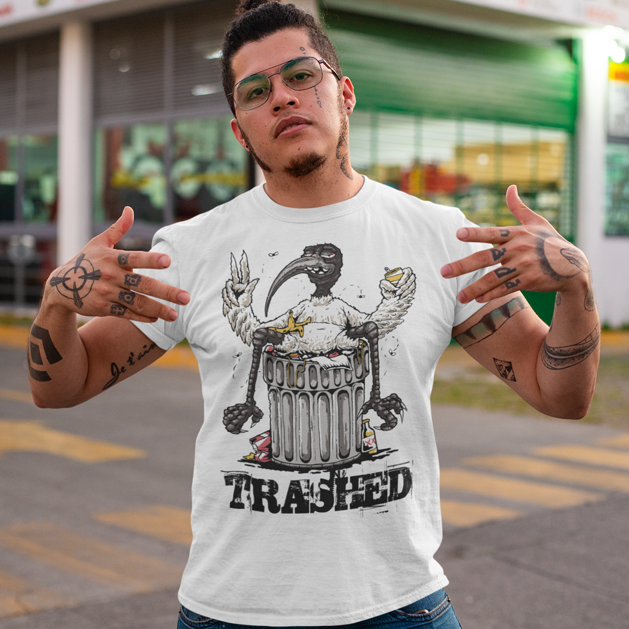 White t-shirt with a bird sitting on a trash can with text "TRASHED".