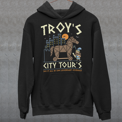 Black hoodie featuring a colorful “TROY’S CITY TOURS” graphic with a stylized Trojan horse rolling through an ancient city at sunset. The design includes a small cartoon Trojan warrior and the phrase “SEE IT ALL IN ONE LEGENDARY JOURNEY.” A fun ancient history and Greek mythology themed shirt for history buffs, mythology fans, travelers, and archaeology enthusiasts.