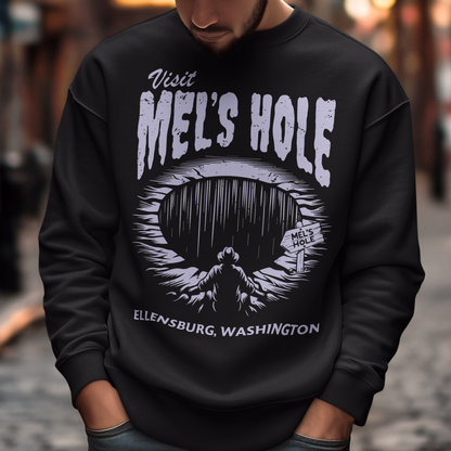 Step into the strange with this quirky and mysterious shirt! Featuring a bold illustration of a curious man peering into a dark, bottomless abyss, this shirt pays homage to the legendary paranormal tale of&nbsp;Mel's Hole — a supposed infinite pit in the wilds of Washington State. The vintage-style artwork is topped with the eerie invitation: "VISIT MEL'S HOLE" in retro tourism font, blending humor, folklore, and a dash of the unexplained.