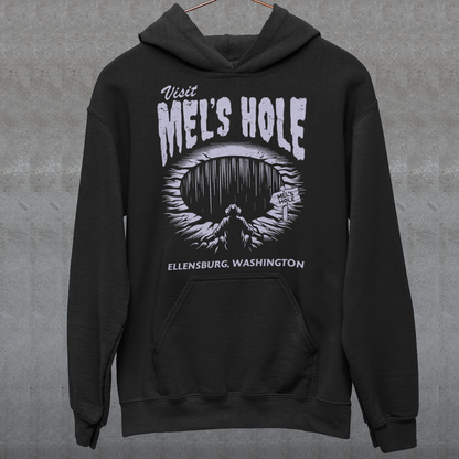 Step into the strange with this quirky and mysterious hoodie! Featuring a bold illustration of a curious man peering into a dark, bottomless abyss, this hoodie pays homage to the legendary paranormal tale of Mel's Hole — a supposed infinite pit in the wilds of Washington State. The vintage-style artwork is topped with the eerie invitation: "VISIT MEL'S HOLE" in retro tourism font, blending humor, folklore, and a dash of the unexplained.