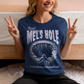 Step into the strange with this quirky and mysterious tee! Featuring a bold illustration of a curious man peering into a dark, bottomless abyss, this shirt pays homage to the legendary paranormal tale of Mel's Hole — a supposed infinite pit in the wilds of Washington State. The vintage-style artwork is topped with the eerie invitation: "VISIT MEL'S HOLE" in retro tourism font, blending humor, folklore, and a dash of the unexplained.