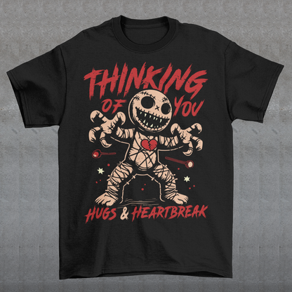 Dark humor meets twisted sweetness with this bold tee. Featuring a stitched-up voodoo doll at the center, the design captures that perfect mix of love and pain. Above the doll, the phrase “THINKING OF YOU” adds a playful sting, while below, “HUGS & HEARTBREAK” ties it all together with equal parts irony and affection. Perfect for anyone who loves edgy, alternative fashion—or just wants to send a cheeky message without saying a word.