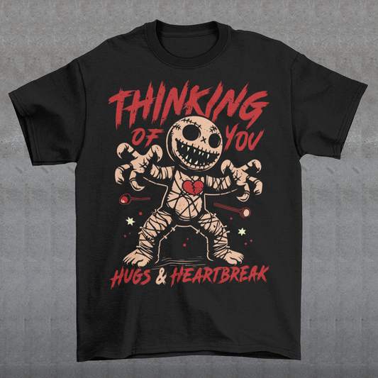 Dark humor meets twisted sweetness with this bold tee. Featuring a stitched-up voodoo doll at the center, the design captures that perfect mix of love and pain. Above the doll, the phrase “THINKING OF YOU” adds a playful sting, while below, “HUGS & HEARTBREAK” ties it all together with equal parts irony and affection. Perfect for anyone who loves edgy, alternative fashion—or just wants to send a cheeky message without saying a word.