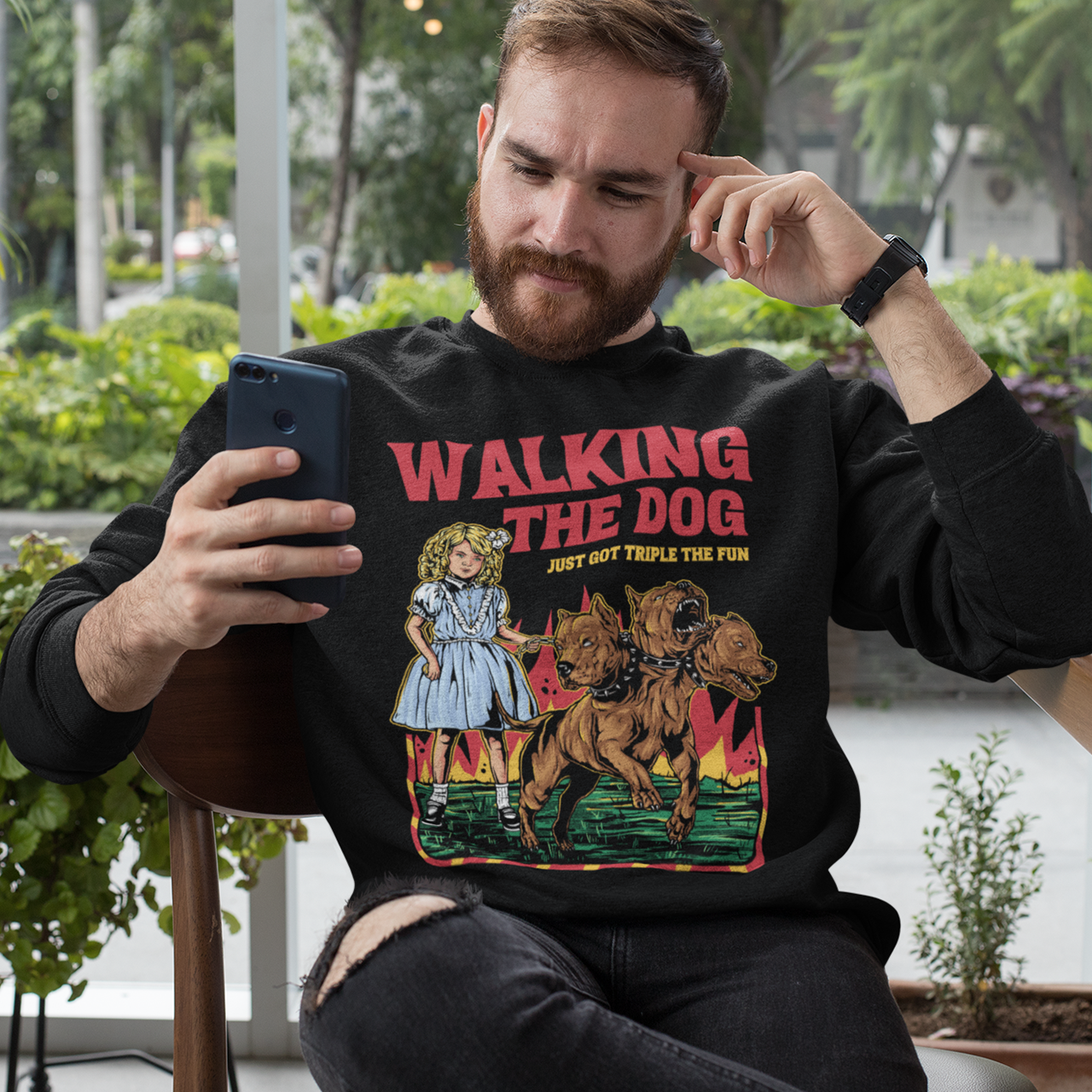 Black sweatshirt of a girl taking Cerberus dog for a walk with text WALKING THE DOG JUST GOT TRIPLE THE FUN.