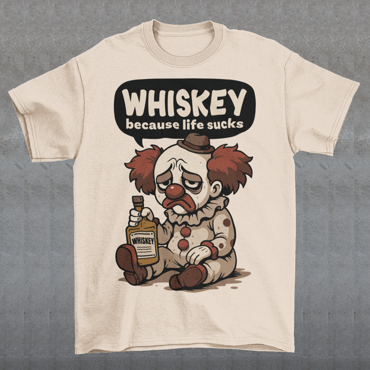 Cream t-shirt featuring a sad cartoon clown with messy red hair and a tired expression, sitting on the ground holding a bottle labeled whiskey. Above the character, bold text reads “Whiskey because life sucks.” The design combines dark humor with a playful cartoon style, creating a sarcastic and slightly edgy visual.