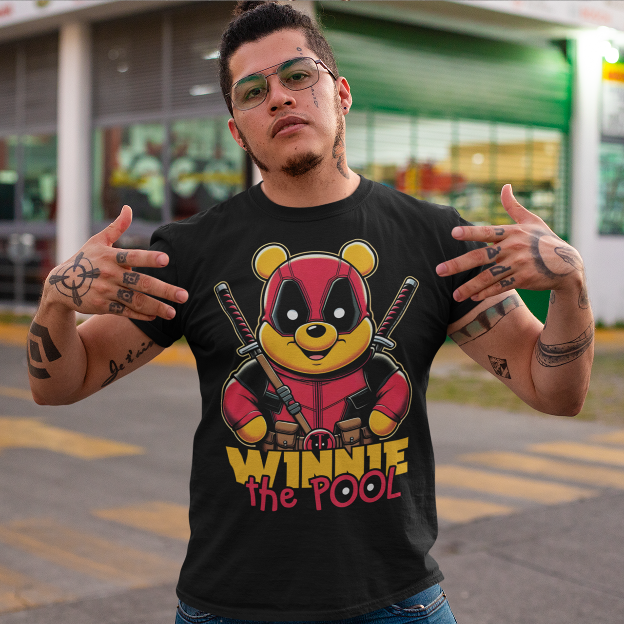 Black t-shirt of Winnie the pooh dressed as a mercenary with samurai swords and text underneath "WINNIE THE POOL".