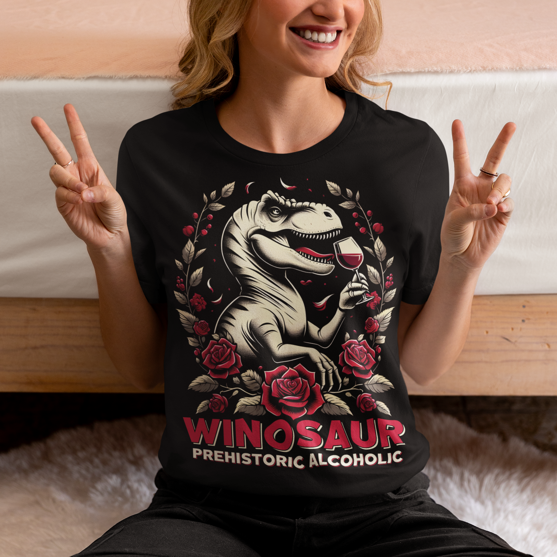 Black t-shirt of a T-Rex drinking wine with text below WINOSAUR PREHISTORIC ALCOHOLIC.