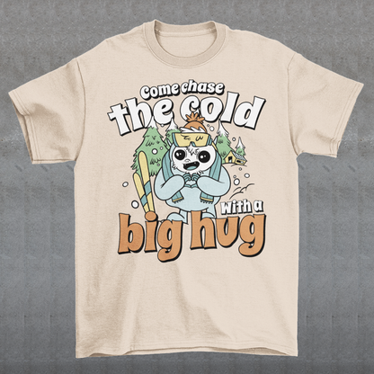 Hit the slopes in style with this playful Yeti Skiing t-shirt! Featuring a whimsical illustration of a friendly yeti standing in the snow, this design pairs perfectly with the cozy, heartwarming message: "Come chase the cold with a big hug." Whether you're a winter sports enthusiast or just love mythical creatures with a soft side, this tee wraps comfort, humor, and chill vibes into one awesome package.