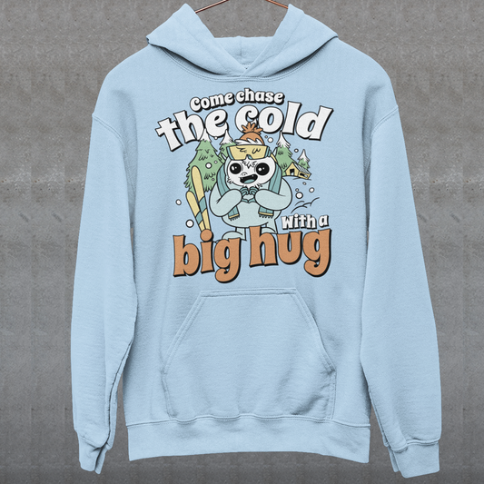 Hit the slopes in style with this playful Yeti Skiing hoodie! Featuring a whimsical illustration of a friendly yeti standing in the snow, this design pairs perfectly with the cozy, heartwarming message: "Come chase the cold with a big hug." Whether you're a winter sports enthusiast or just love mythical creatures with a soft side, this hoodie wraps comfort, humor, and chill vibes into one awesome package.