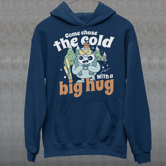 Hit the slopes in style with this playful Yeti Skiing hoodie! Featuring a whimsical illustration of a friendly yeti standing in the snow, this design pairs perfectly with the cozy, heartwarming message: "Come chase the cold with a big hug." Whether you're a winter sports enthusiast or just love mythical creatures with a soft side, this hoodie wraps comfort, humor, and chill vibes into one awesome package.