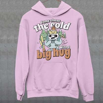 Hit the slopes in style with this playful Yeti Skiing hoodie! Featuring a whimsical illustration of a friendly yeti standing in the snow, this design pairs perfectly with the cozy, heartwarming message: "Come chase the cold with a big hug." Whether you're a winter sports enthusiast or just love mythical creatures with a soft side, this hoodie wraps comfort, humor, and chill vibes into one awesome package.